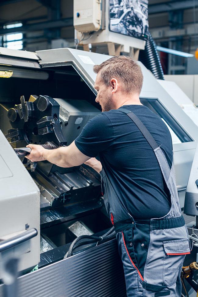 Technician performing cnc preventative maintenance as part of CNC repair service